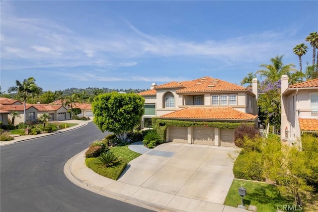 2155 Chandler Dr, Tustin, CA 92782 - mediterranean / spanish-style home featuring driveway, stucco siding, a tiled roof, and a chimney