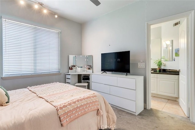 2155 Chandler Dr, Tustin, CA 92782 - bedroom with light colored carpet, ensuite bath, and ceiling fan