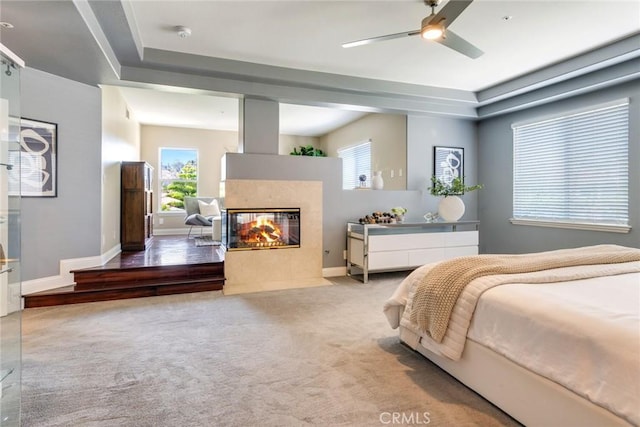 2155 Chandler Dr, Tustin, CA 92782 - bedroom featuring a multi sided fireplace, multiple windows, and light carpet