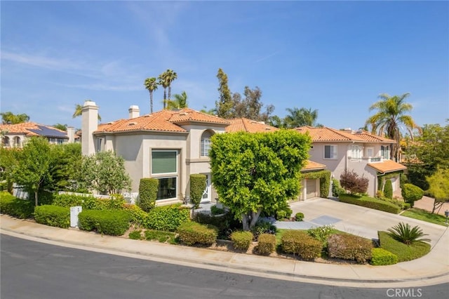 2155 Chandler Dr, Tustin, CA 92782 - mediterranean / spanish-style house with a tile roof, stucco siding, driveway, and a chimney