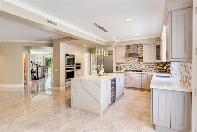 2155 Chandler Dr, Tustin, CA 92782 - kitchen with wall chimney exhaust hood, beverage cooler, stainless steel appliances, backsplash, and a center island