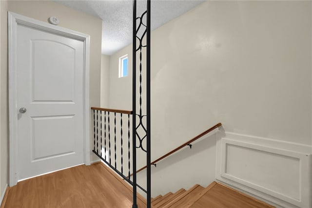 112 E Central Ave, San Gabriel, CA 91776 - stairs with a textured ceiling and wood finished floors