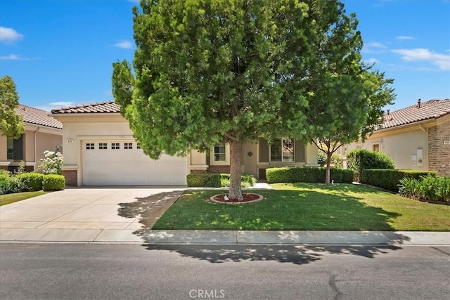 875 Eastlake Rd, Beaumont, CA 92223 - view of front facade featuring an attached garage, driveway, stucco siding, a front lawn, and a tiled roof