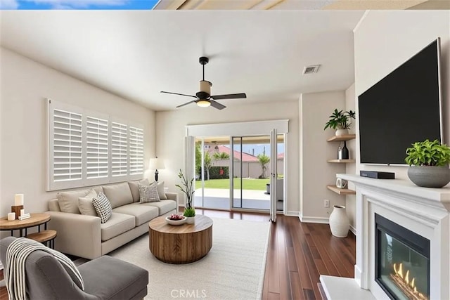 875 Eastlake Rd, Beaumont, CA 92223 - living area with dark wood-type flooring, a ceiling fan, and a glass covered fireplace