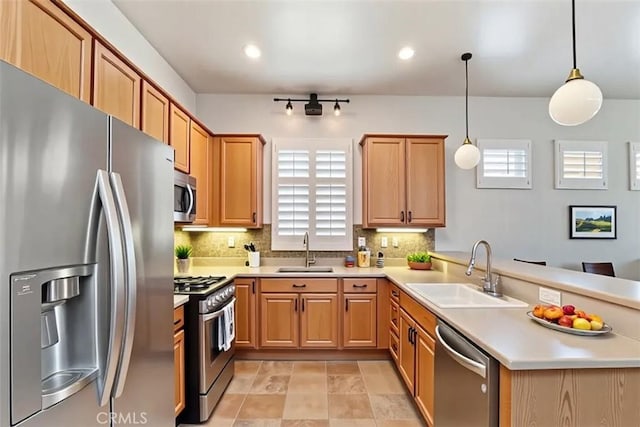 875 Eastlake Rd, Beaumont, CA 92223 - kitchen featuring appliances with stainless steel finishes, a peninsula, decorative backsplash, light countertops, and recessed lighting