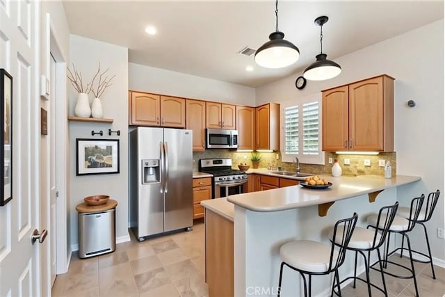 875 Eastlake Rd, Beaumont, CA 92223 - kitchen with appliances with stainless steel finishes, a peninsula, tasteful backsplash, a kitchen bar, and light countertops