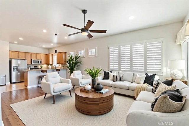 875 Eastlake Rd, Beaumont, CA 92223 - living room featuring light wood-type flooring, a ceiling fan, and recessed lighting