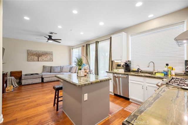 2635 Sunshine Valley Ct, Simi Valley, CA 93063 - kitchen featuring stainless steel dishwasher, light stone counters, a kitchen island, white cabinets, and recessed lighting
