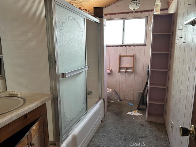 13923 Meadow Ln, Lytle Creek, CA 92358 - bathroom featuring vanity, wood walls, and bath / shower combo with glass door