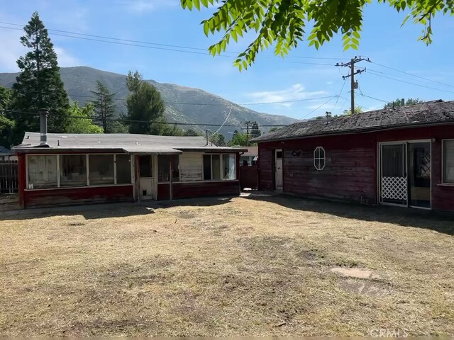 13923 Meadow Ln, Lytle Creek, CA 92358 - rear view of house with a mountain view and a sunroom