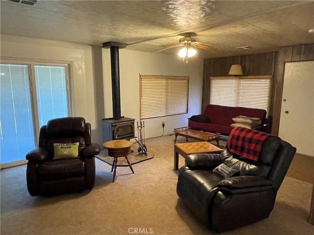 3236 Partridge Ln, Paso Robles, CA 93446 - living area featuring a wood stove, light carpet, and ceiling fan