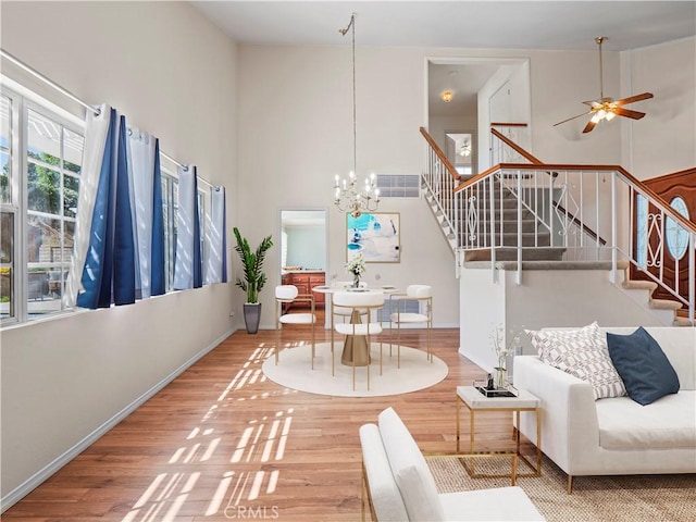 22905 Las Mananitas Dr, Valencia, CA 91354 - living area featuring wood finished floors, stairs, a towering ceiling, a chandelier, and a ceiling fan