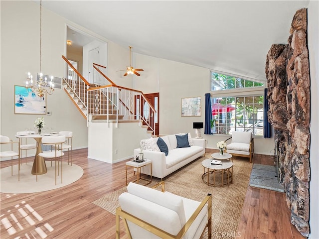 22905 Las Mananitas Dr, Valencia, CA 91354 - living area featuring stairway, wood finished floors, high vaulted ceiling, a chandelier, and ceiling fan