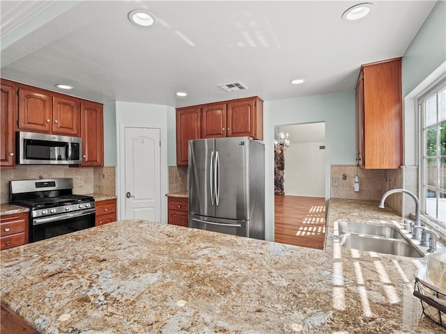 22905 Las Mananitas Dr, Valencia, CA 91354 - kitchen featuring stainless steel appliances, recessed lighting, light stone countertops, tasteful backsplash, and a peninsula
