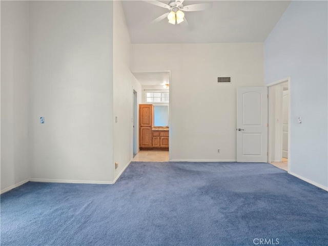 22905 Las Mananitas Dr, Valencia, CA 91354 - empty room featuring light colored carpet, ceiling fan, and a towering ceiling