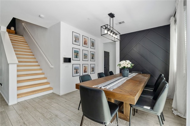 4360 Rima Dr, Fontana, CA 92336 - dining area with stairs, light wood-type flooring, and a chandelier