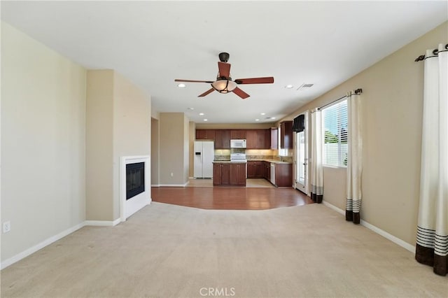 1544 Big Bnd, Beaumont, CA 92223 - unfurnished living room with light carpet, ceiling fan, recessed lighting, and a glass covered fireplace