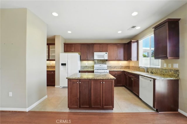 1544 Big Bnd, Beaumont, CA 92223 - kitchen with white appliances, a kitchen island, light stone countertops, recessed lighting, and light tile patterned flooring