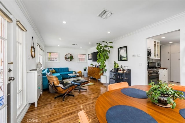 4115 E 10th St, Long Beach, CA 90804 - living room with light wood finished floors, crown molding, and recessed lighting