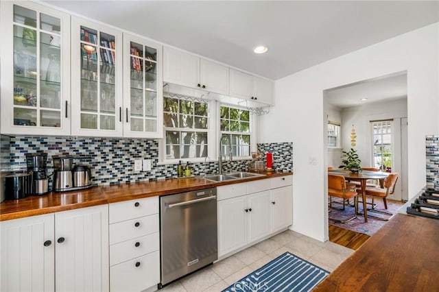 4115 E 10th St, Long Beach, CA 90804 - kitchen featuring butcher block countertops, stainless steel dishwasher, backsplash, white cabinets, and glass insert cabinets