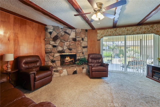 12429 Baker Ave, Chino, CA 91710 - living room with carpet flooring, beam ceiling, a textured ceiling, wood walls, and a stone fireplace