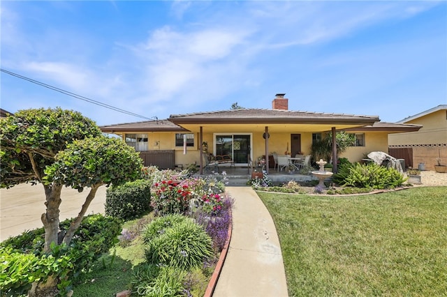 12429 Baker Ave, Chino, CA 91710 - view of front of home featuring a chimney, a front yard, and stucco siding