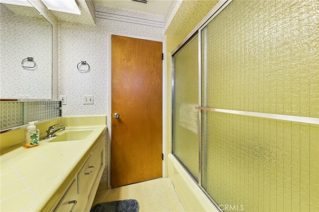 12429 Baker Ave, Chino, CA 91710 - full bathroom with wallpapered walls, vanity, shower / bath combination with glass door, and tile patterned floors