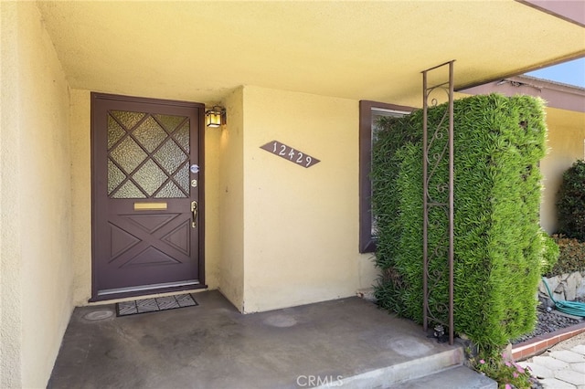 12429 Baker Ave, Chino, CA 91710 - doorway to property featuring stucco siding