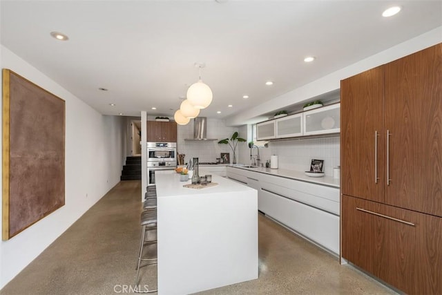 417 Sunset Ave Unit 1.2, Venice, CA 90291 - kitchen featuring stainless steel double oven, wall chimney range hood, open shelves, recessed lighting, and tasteful backsplash