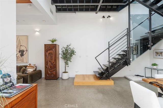 417 Sunset Ave Unit 1.2, Venice, CA 90291 - staircase featuring speckled floor and a high ceiling