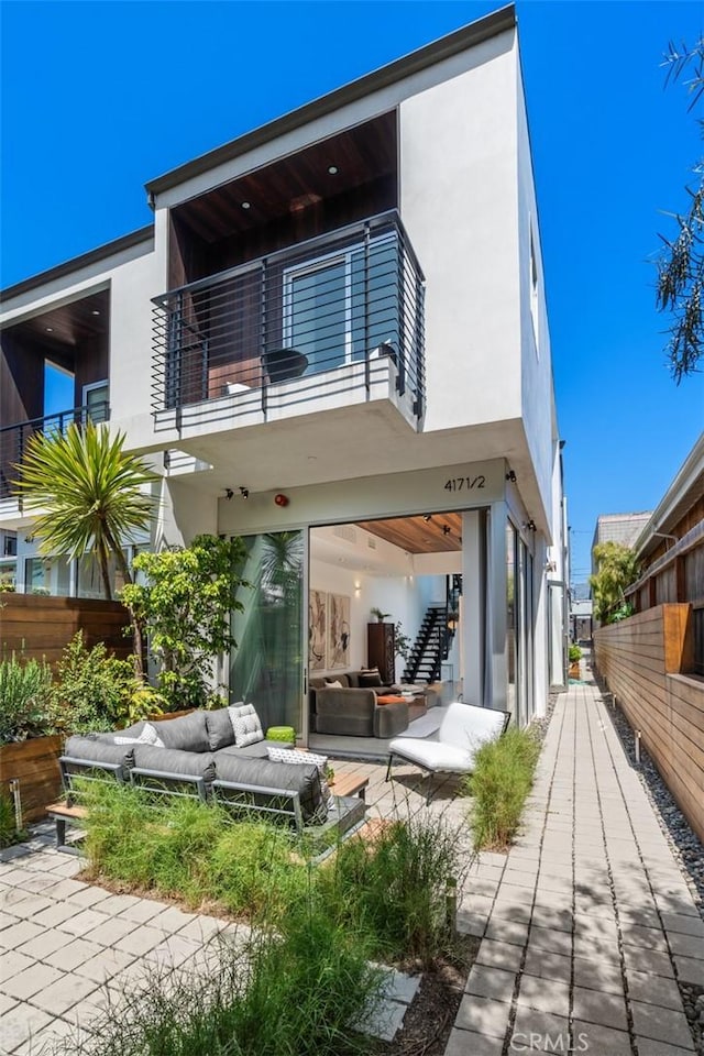 417 Sunset Ave Unit 1.2, Venice, CA 90291 - rear view of property with an outdoor hangout area, a balcony, stucco siding, stairway, and a patio