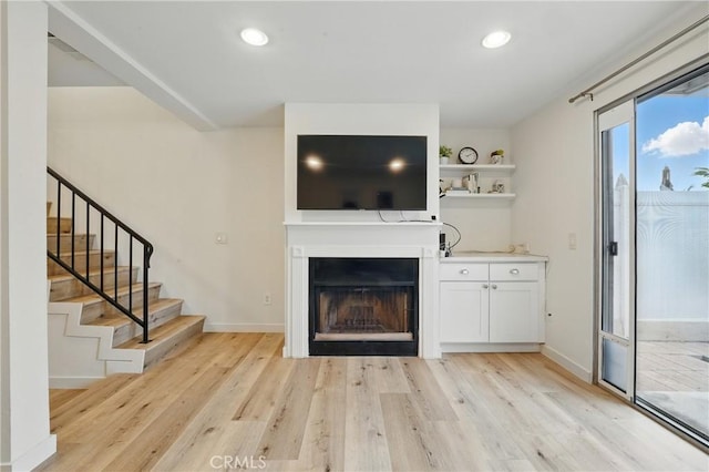 14861 Mulberry Dr Unit 1310, Whittier, CA 90604 - unfurnished living room featuring light wood finished floors, stairs, recessed lighting, and a fireplace
