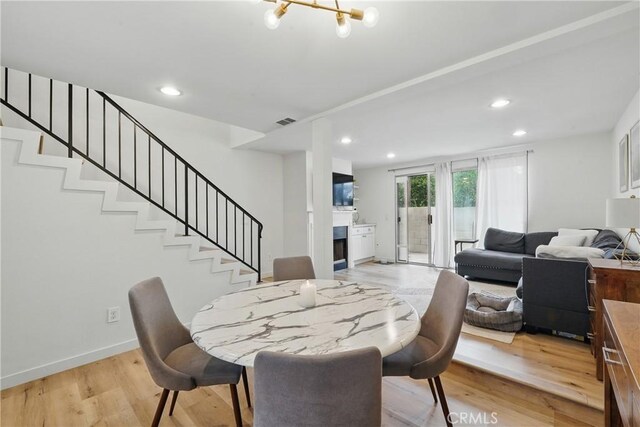 14861 Mulberry Dr Unit 1310, Whittier, CA 90604 - dining room featuring stairs, a fireplace, recessed lighting, and light wood-style floors