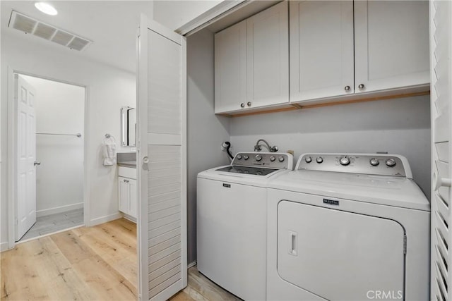 14861 Mulberry Dr Unit 1310, Whittier, CA 90604 - laundry room featuring cabinet space, washer and dryer, and light wood finished floors