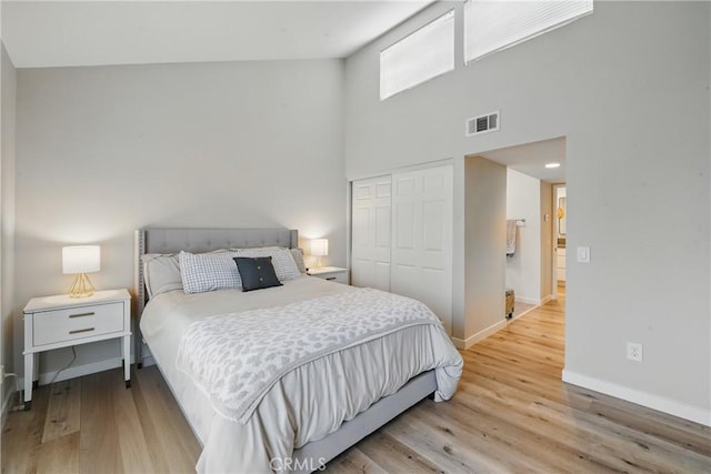 14861 Mulberry Dr Unit 1310, Whittier, CA 90604 - bedroom featuring a closet, light wood-type flooring, and a towering ceiling
