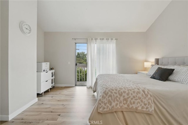 14861 Mulberry Dr Unit 1310, Whittier, CA 90604 - bedroom with access to exterior, lofted ceiling, and light wood finished floors