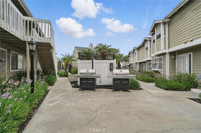14861 Mulberry Dr Unit 1310, Whittier, CA 90604 - view of patio with grilling area, a residential view, and stairway