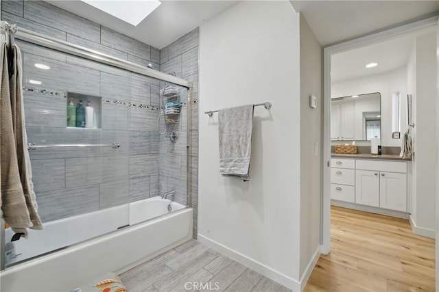 14861 Mulberry Dr Unit 1310, Whittier, CA 90604 - full bath featuring a skylight, wood finished floors, vanity, combined bath / shower with glass door, and recessed lighting