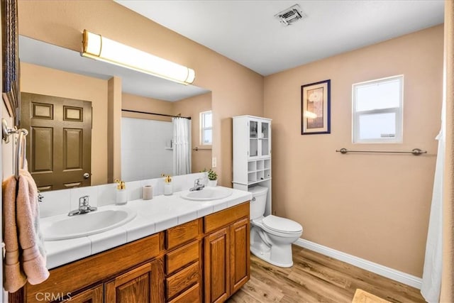 3715 Surrey, Yucca Valley, CA 92284 - bathroom featuring double vanity, wood finished floors, and curtained shower