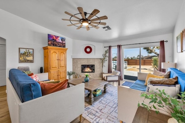 3715 Surrey, Yucca Valley, CA 92284 - living area featuring lofted ceiling, a ceiling fan, wood finished floors, and a fireplace