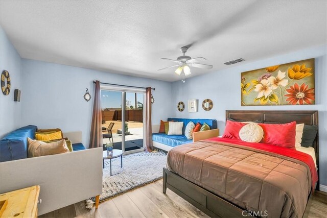 3715 Surrey, Yucca Valley, CA 92284 - bedroom featuring wood finished floors, access to outside, ceiling fan, and a textured ceiling