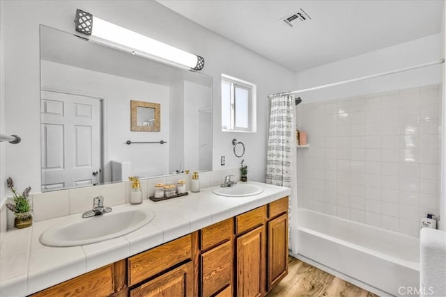 3715 Surrey, Yucca Valley, CA 92284 - full bath with double vanity, shower / bath combo with shower curtain, and wood finished floors