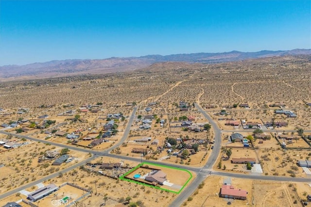 3715 Surrey, Yucca Valley, CA 92284 - overview of rural landscape featuring a mountain backdrop and property parcel outlined