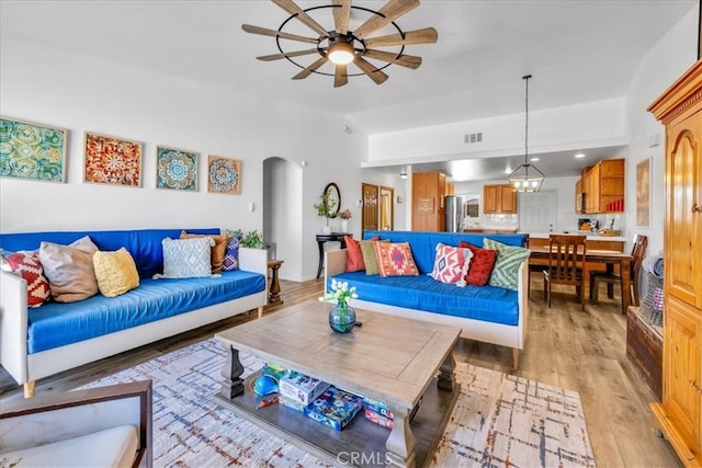 3715 Surrey, Yucca Valley, CA 92284 - living room featuring a ceiling fan, arched walkways, and light wood-style floors