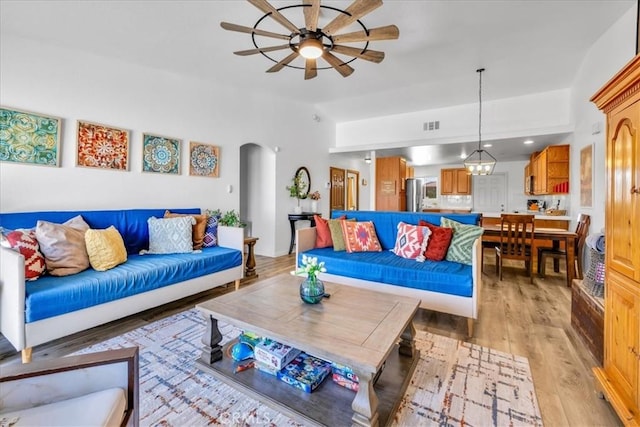 3715 Surrey, Yucca Valley, CA 92284 - living area featuring ceiling fan, arched walkways, and light wood finished floors