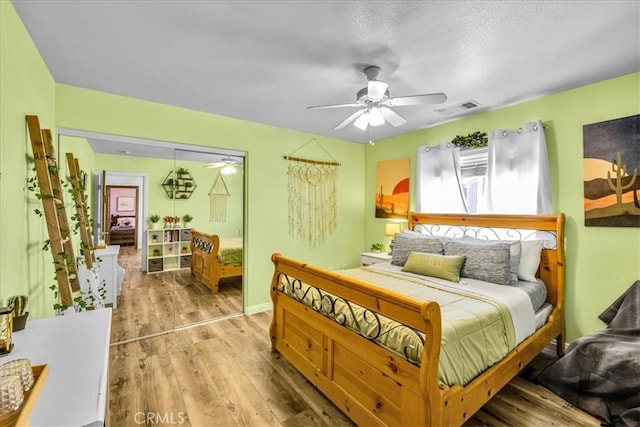 3715 Surrey, Yucca Valley, CA 92284 - bedroom with wood finished floors, ceiling fan, and a textured ceiling