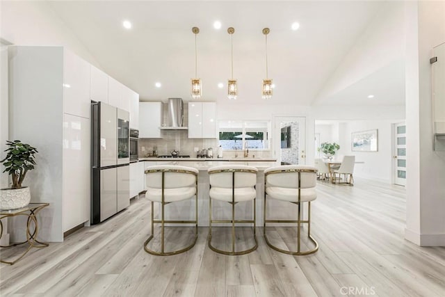 23500 Lloyd Houghton Pl, Newhall, CA 91321 - kitchen featuring appliances with stainless steel finishes, wall chimney range hood, modern cabinets, white cabinetry, and backsplash