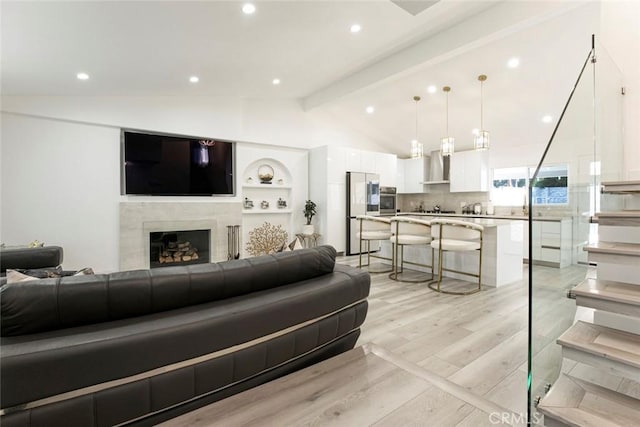 23500 Lloyd Houghton Pl, Newhall, CA 91321 - living area featuring light wood-type flooring, a high end fireplace, and recessed lighting