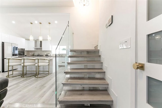 23500 Lloyd Houghton Pl, Newhall, CA 91321 - stairs with wood finished floors and lofted ceiling
