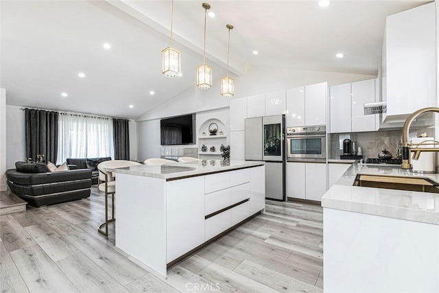 23500 Lloyd Houghton Pl, Newhall, CA 91321 - kitchen with appliances with stainless steel finishes, modern cabinets, open floor plan, and recessed lighting